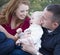 Young Parents Laughing with Child Boy in Park