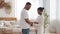 Young parents married african couple afro american black ethnic family stand in home interior man touches puts hands on