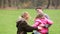 Young parents playing with daughter in park