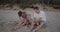 Young parents playing with their toddler son on the beach