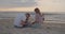 Young parents playing with their toddler son on the beach