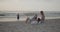 Young parents playing with their toddler son on the beach