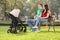 Young parents sitting with their baby in park