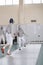 Young participants of the fencing tournament fighting in protective white clothes