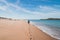 Young, passionate black-haired dobby runs from the waves of the Atlantic Ocean on a sandy beach near Porto Covo, Portugal. In the