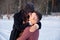 Young passionate couple hugging on a winter day on the park