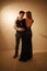 Young passionate dancing couple in love in classic style in studio ballroom