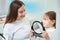 Young patient smiling at her joyous pedodontist after dental treatment