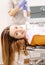 Young patient waits on the table looking at camera and smiling