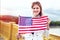 Young patriot american woman with toothy smile stretching USA flag