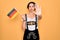 Young patriotic german woman with blue eyes wearing octoberfest dress holding germany flag with open hand doing stop sign with