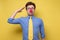 Young patriotic man dressed as clown making salute gesture and ready to do order with funny face.