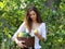 Young peasant girl picking some ripe lemons from a tree