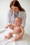 Young pediatrician focused on auscultating a newborn patient