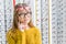 young pensive girl choosing eyeglasses