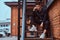 A young pensive guy sitting on stairs outside near a building with the industrial exterior.