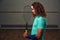 Young pensive racketball player with racket standing backside