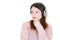 Young pensive woman with headphones listening to music look aside