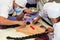 Young people bakers are preparing bread `Guagua`