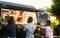 Young people buying meal from street food truck
