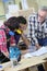 Young people in carpentry training with professor