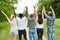 Young people cheer together in the park