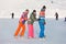 Young people, friends, winter ice-skating on the frozen lake