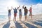 Young People Group On Beach Summer Vacation, Raised Hands Friends Seaside