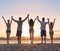 Young People Group On Beach At Sunset Summer Vacation, Friends Holding Hands Up Seaside Back Rear View