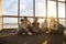 Young People Group Sitting On Floor In Airport Lounge Windows Waiting Departure Speaking Happy Smile Mix Race Friends