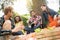 Young people with guitarist having rest in nature