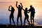 Young people, guys and girls, students are dancing on the beach