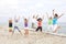 Young people jumping on the beach