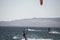 young people kitsurfing in a paracas bay of peru with blue water and drops in the air and mountains in the background-june 2020