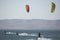 young people kitsurfing in a paracas bay of peru with blue water and drops in the air and mountains in the background-june 2020