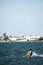 young people kitsurfing in a paracas bay of peru with blue water and drops in the air and mountains in the background-june 2020