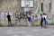 Young people painting graffiti on the wall under the basketball basket