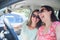 Young people persons on road trip drive in car - cars concept couple driving in new car smiling happy