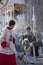 Young people in procession with incense burners in Holy week