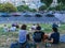 Young people relax and play guitar on hillside overlooking Paris, France