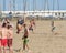 Young people are resting on the beach. Playing volleyball, jumping over your head. Outdoor sporting activity