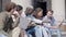 young people share the news sitting on the steps.