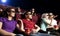 Young people sitting at the cinema, watching a film
