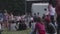 Young people sitting on grass at camping picnic party, having rest at city park