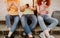 Young people sitting together and using smartphones