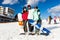 Young people in ski-suits and ski goggles having fun while stand