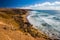 Young people surfing on La Pared beach with vulcanic mountains in the background on Fuerteventura island, Canary Islands, Spain