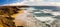 Young people surfing on La Pared beach with vulcanic mountains on Fuerteventura island, Canary Islands, Spain.