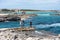 Young people taking photos at Es Pujols beach in Formentera in the summer of 2021