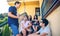 Young people talking outdoors sitting on home stairs steps